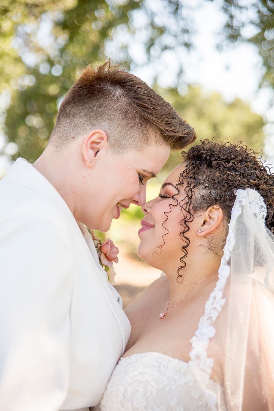 brides touching noses at Roblar Winery in Santa Ynez California