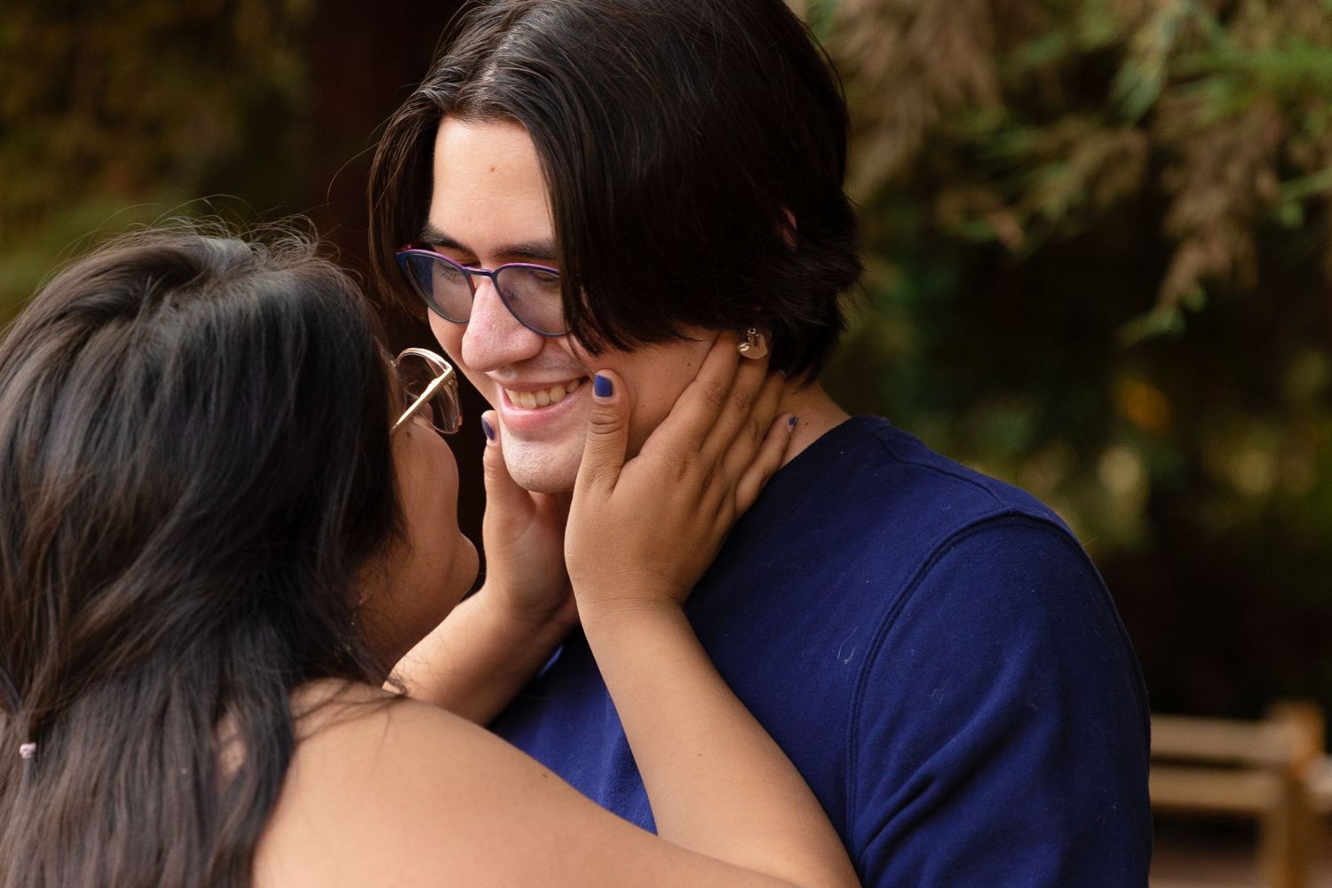 fiance holding her fiances face for a kiss