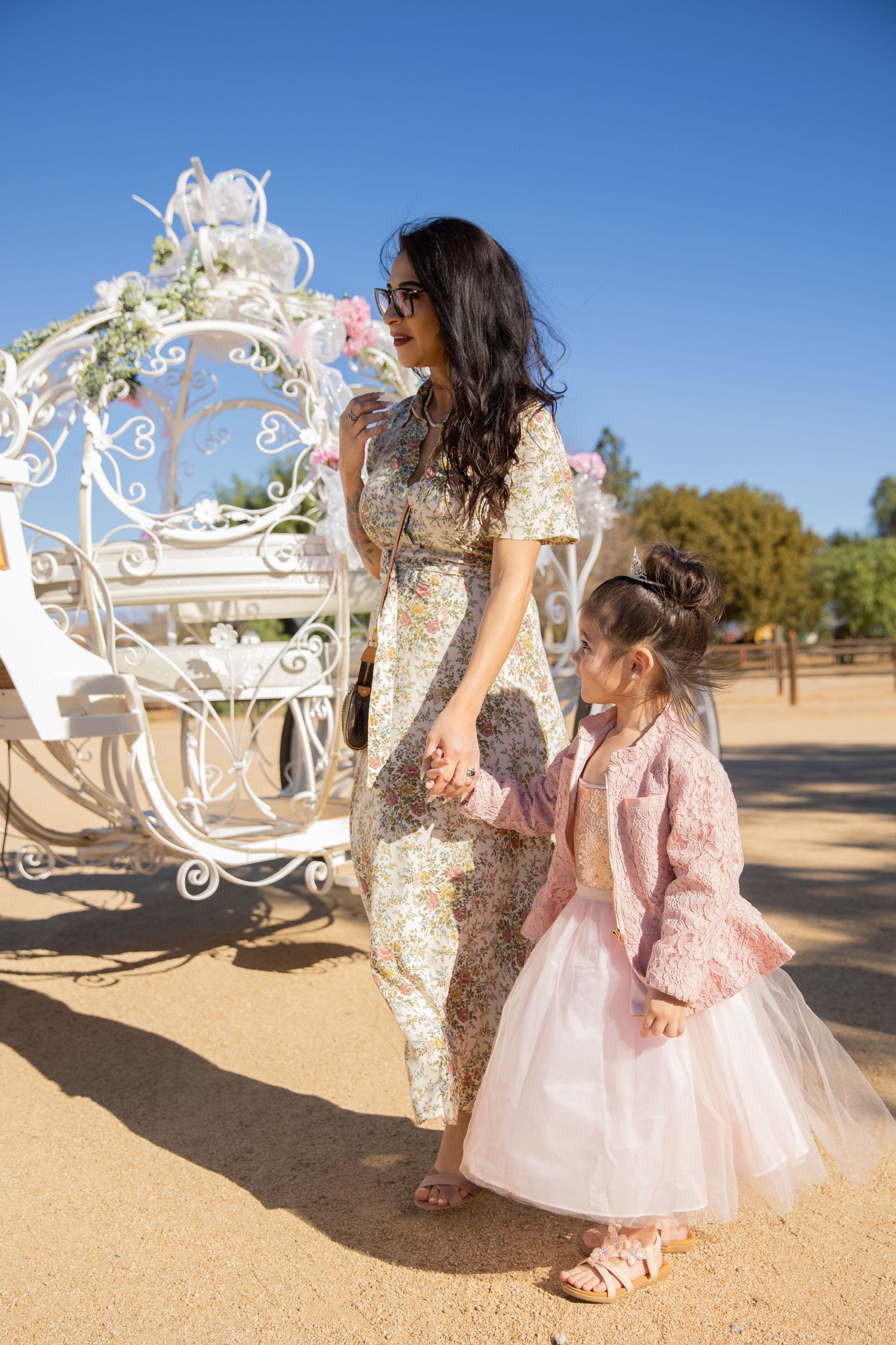 Mother and daughter holding hands while looking at unicorn