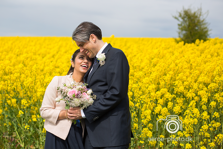 Happy couple at a yellow rapeseed field.