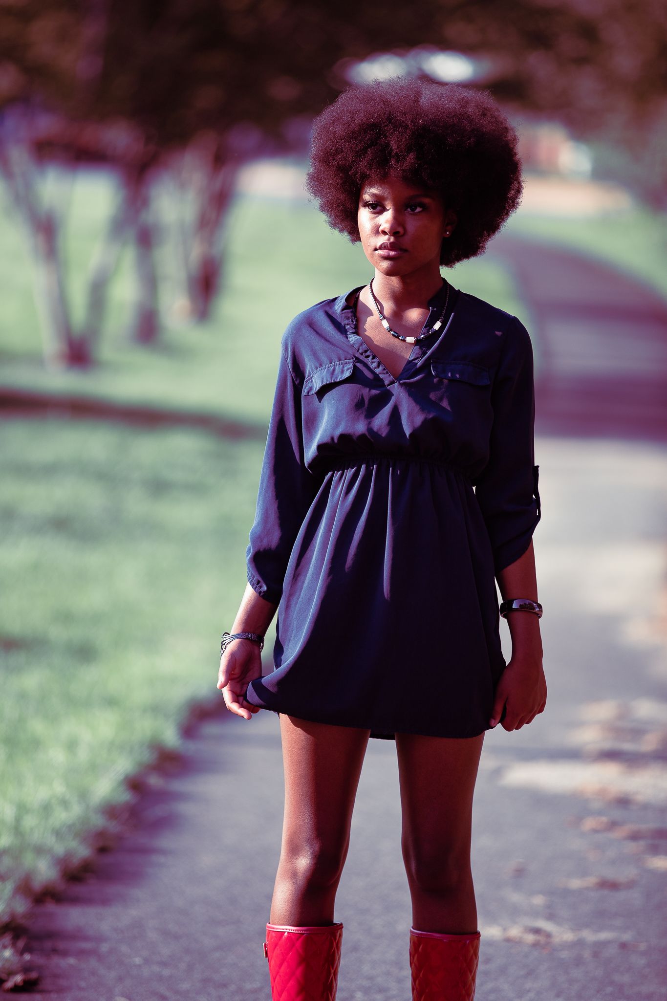 model in blue dress and red boots