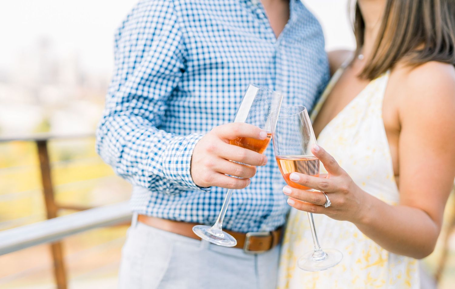 Des Moines Engagement photos with skyline of downtown Des Moines, Iowa with light and airy photographer Nicole Laing