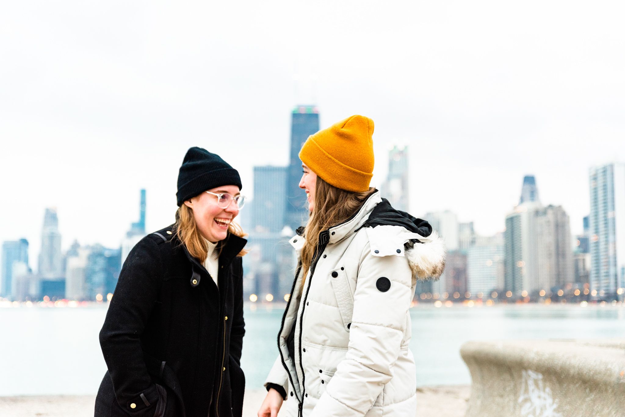 two women laughing after proposal at North Avenue Beach