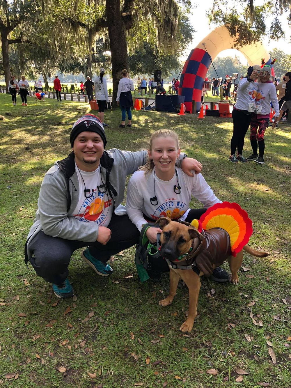 kayley and josh with their dog after a 5k in savannah