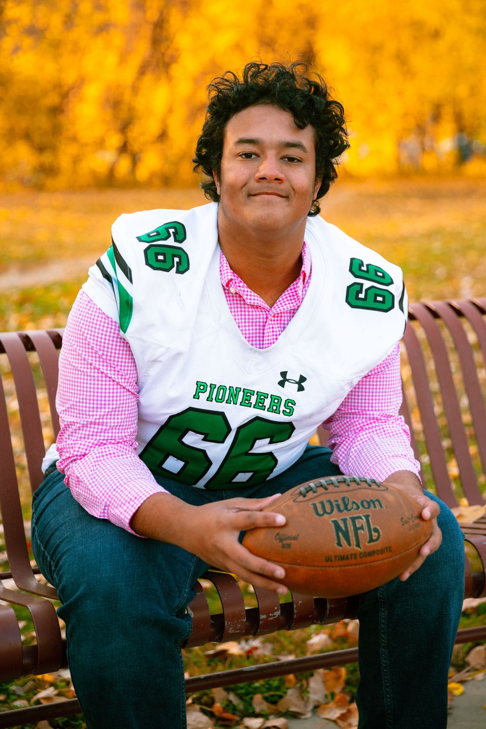 senior football player sitting on a bench