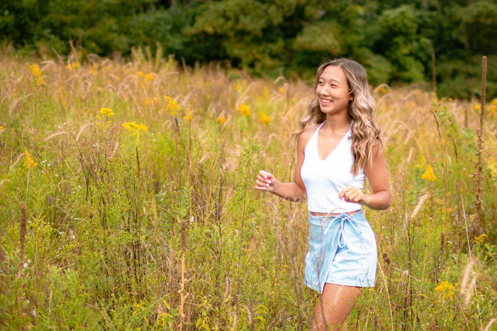 senior girl frolicking in field