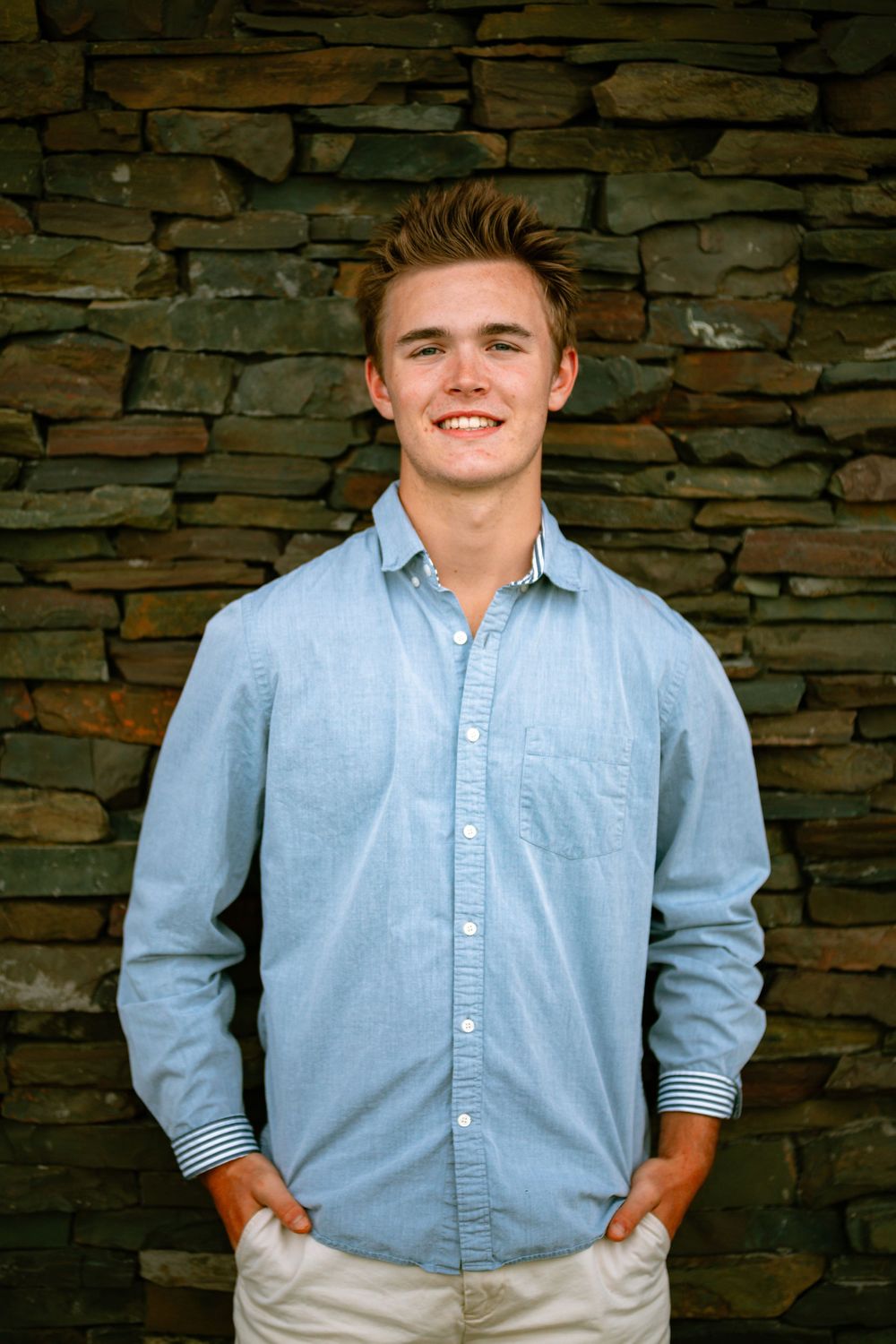 senior boy against brick wall