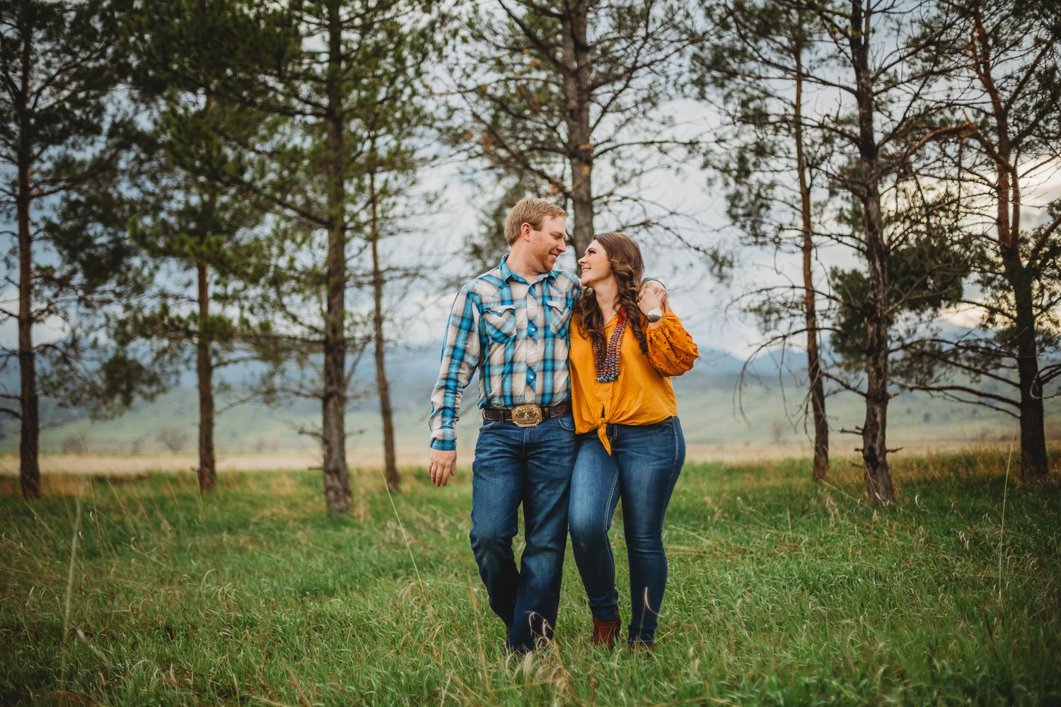 A couple gazes at eachother during their Colorado engagement session at Reservoir Ridge Natural Area in Fort Collins, CO