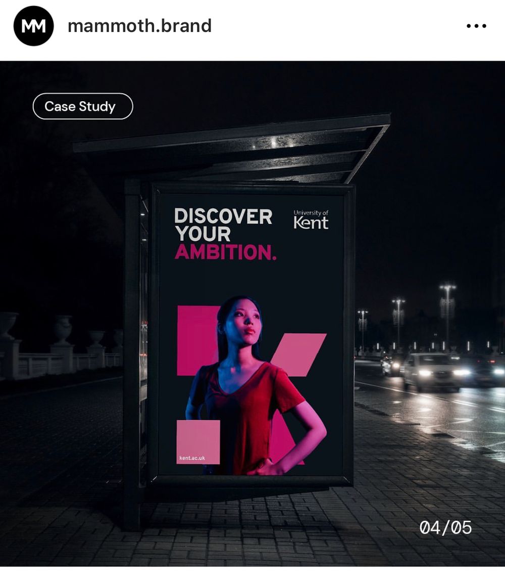 A bus stop poster shows a woman with the slogan 'Discover your Ambition'