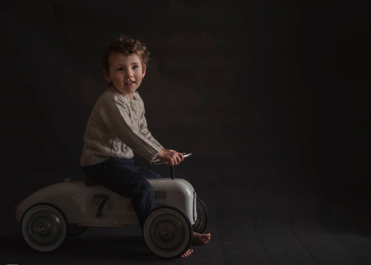 fine art boy on toy car