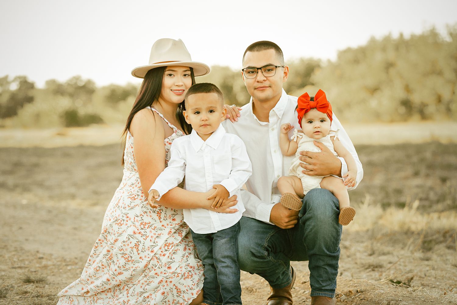 professional colorado family photo session in rocky mountains family of 4 posing in the mountains during sunset golden hour time. liz rivas