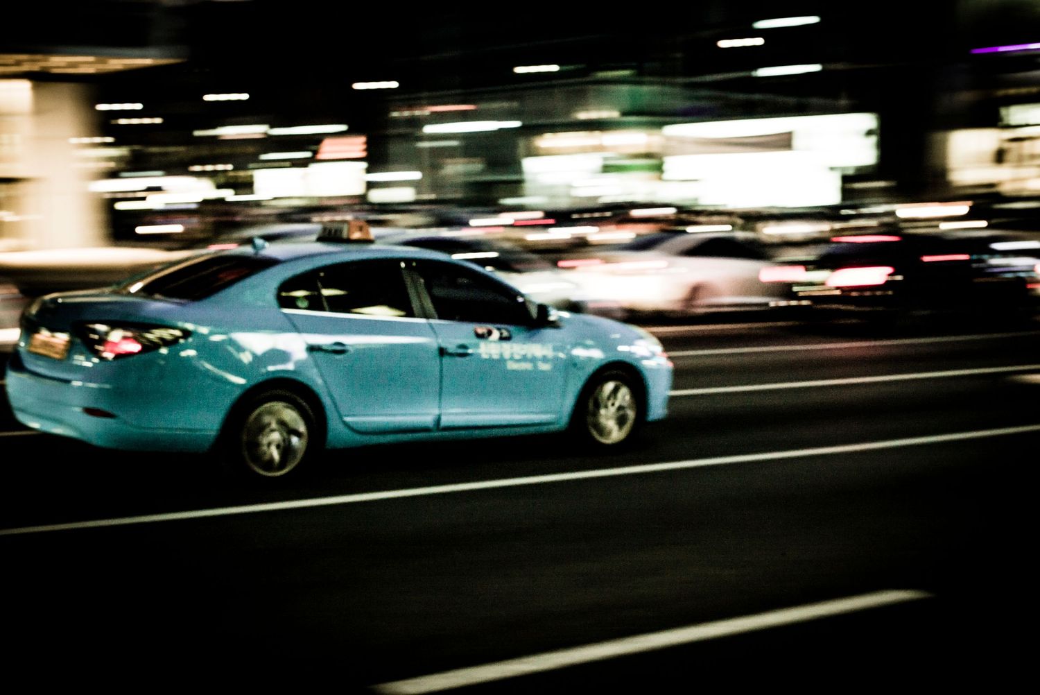 Panned photo of car in downtown streets of Soul South Korea