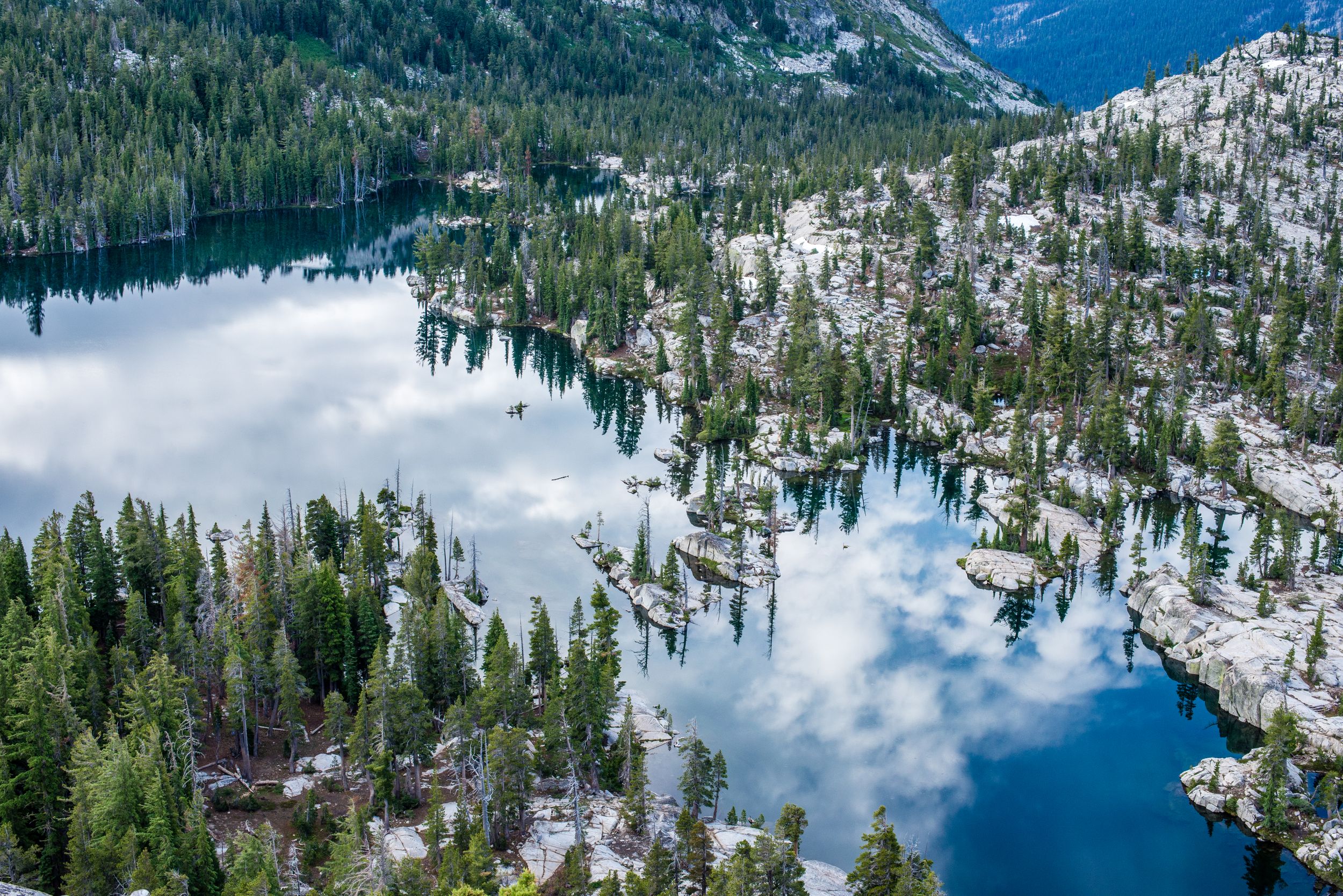 Beautiful reflective view from a peak above lake of the woods in desolation wilderness on the PCT in CA by heidi harting