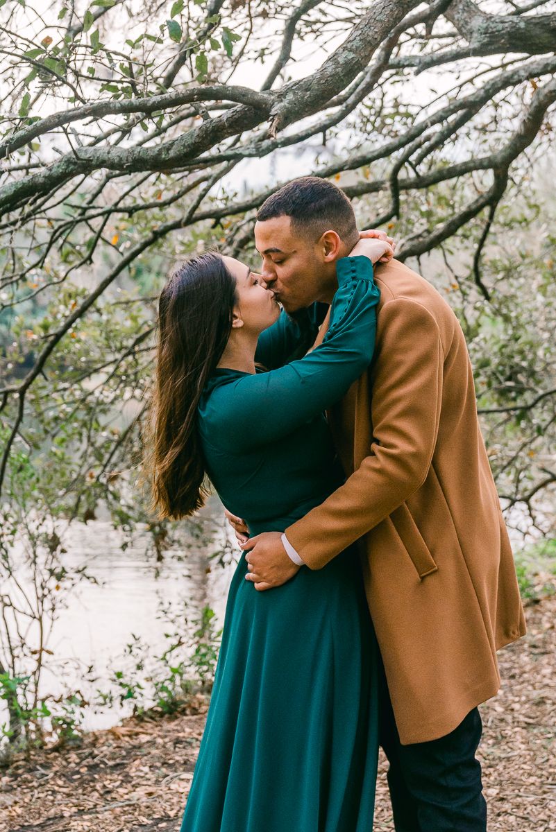 Couple Kissing in City Park Engagement Session