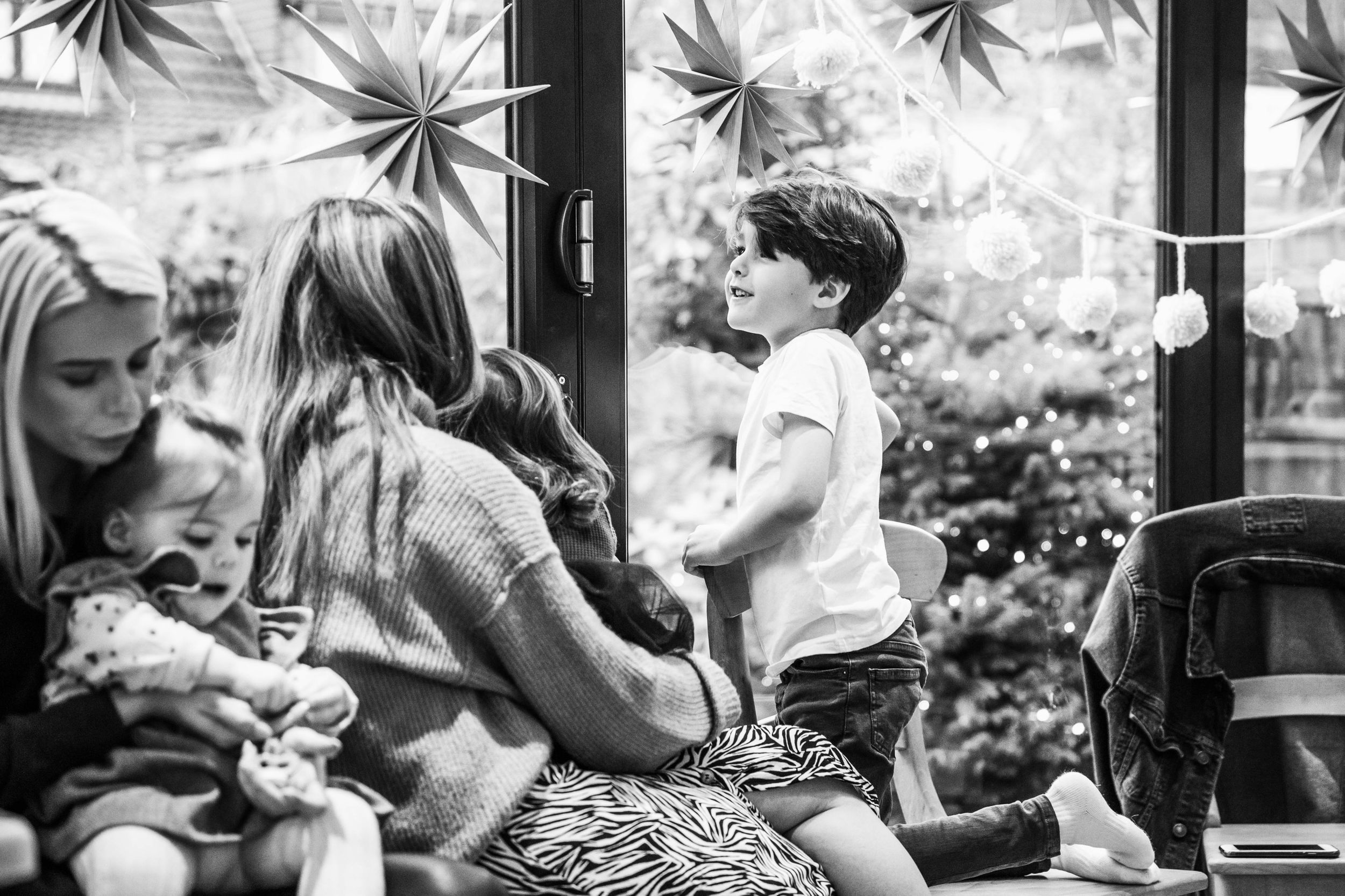 young boy smiling looking out of window