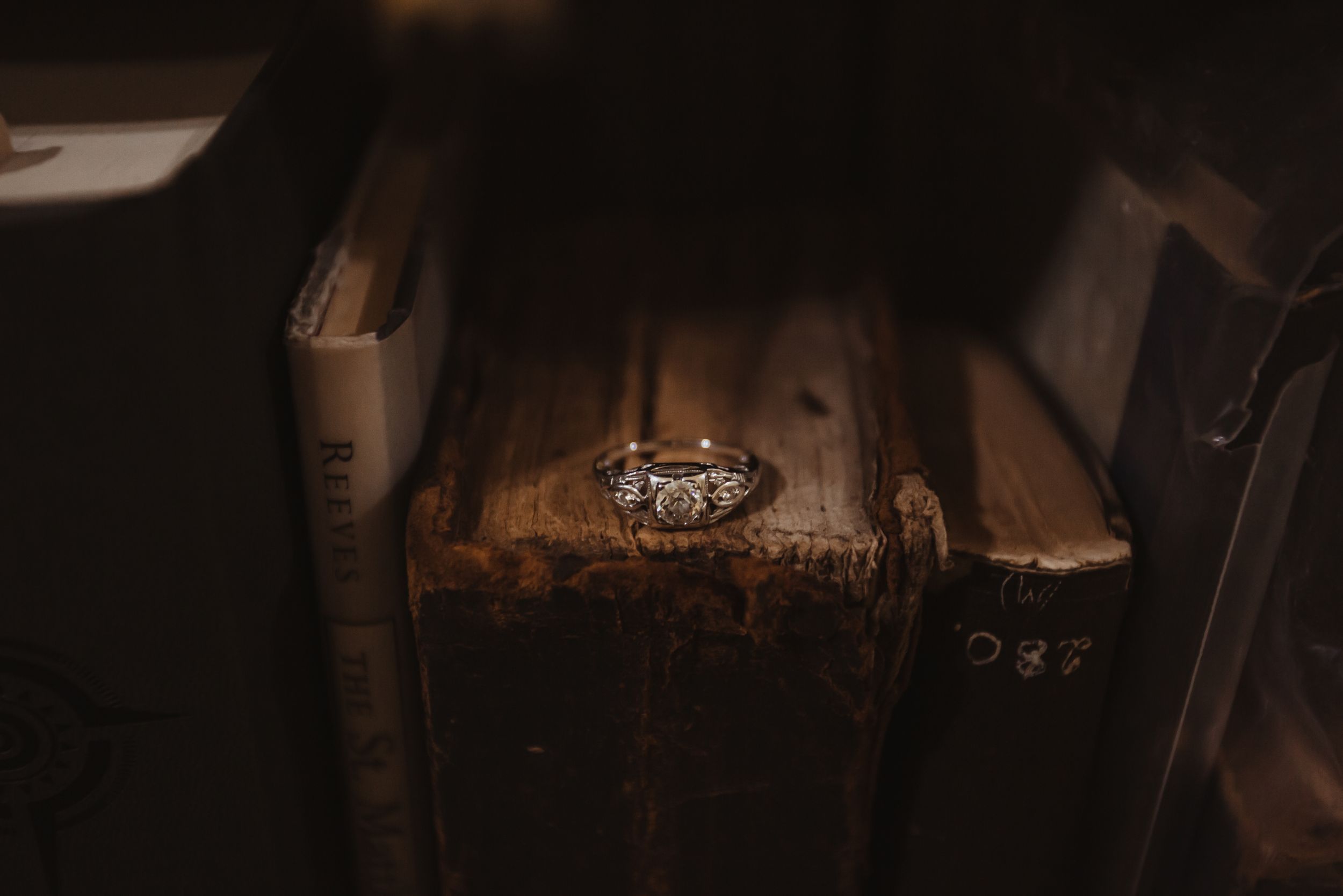 Engagement ring on very old tattered books.