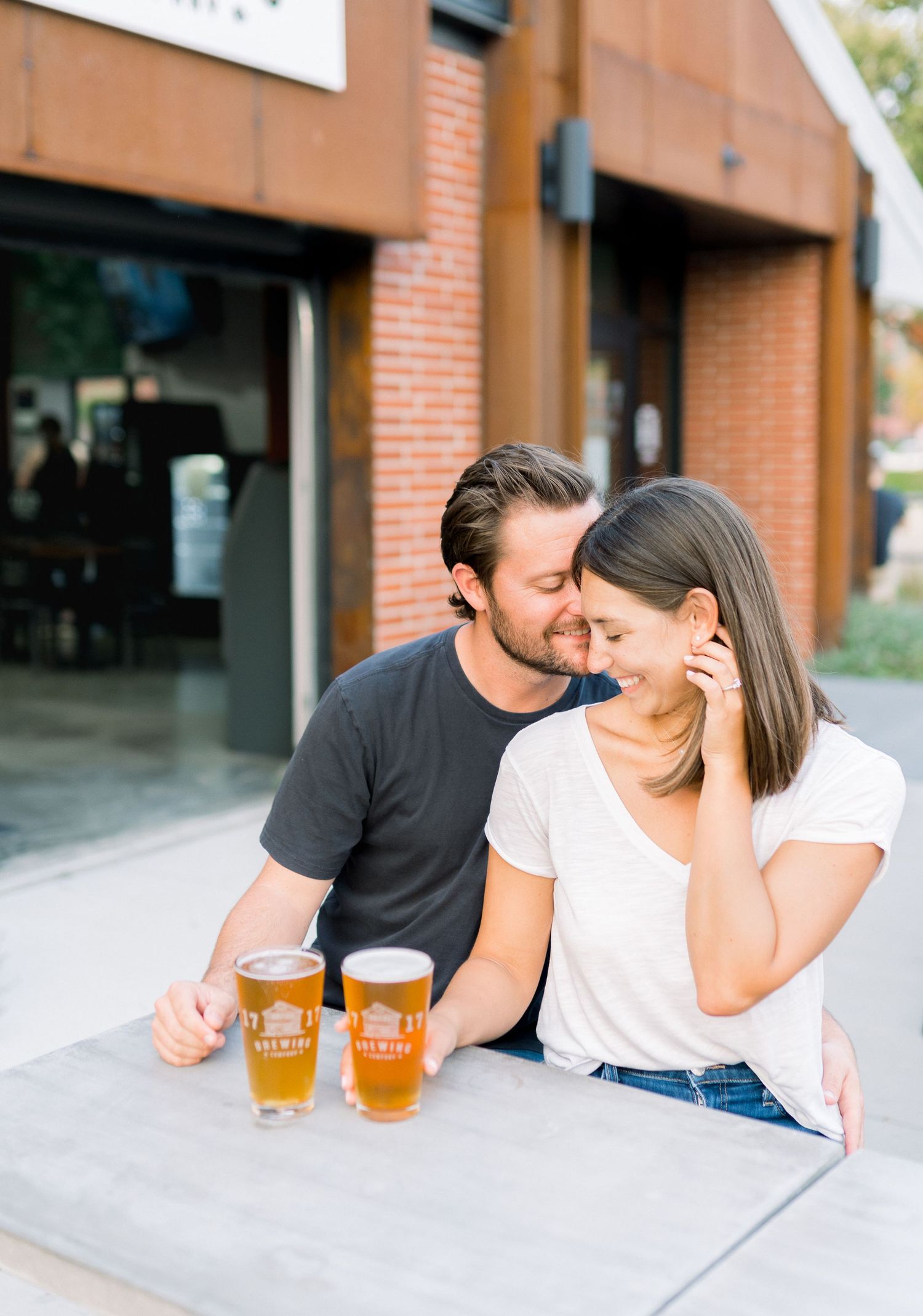 Des Moines Engagement photos at brewery in downtown Des Moines, Iowa with light and airy photographer Nicole Laing