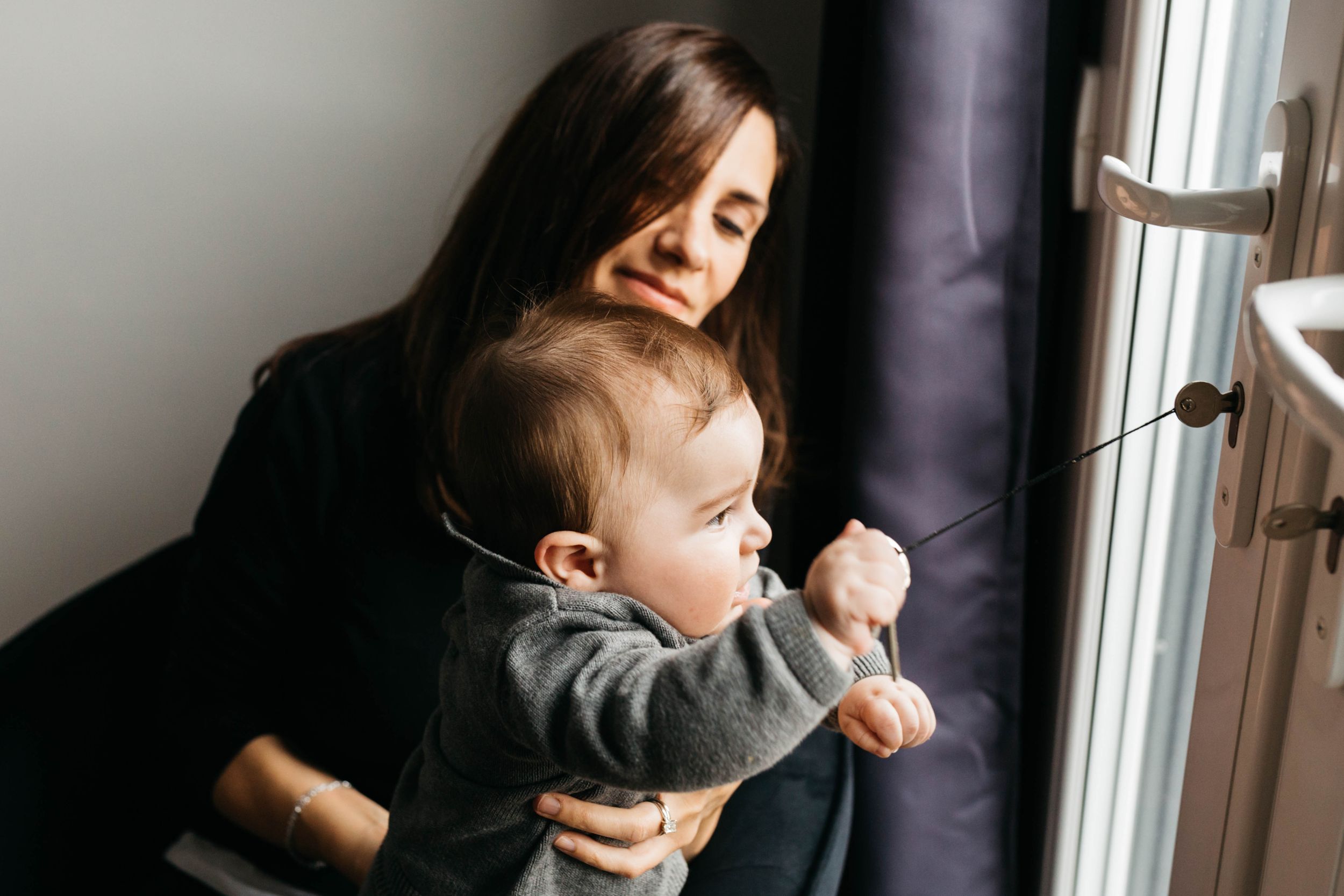 mum and baby boy son sitting by window