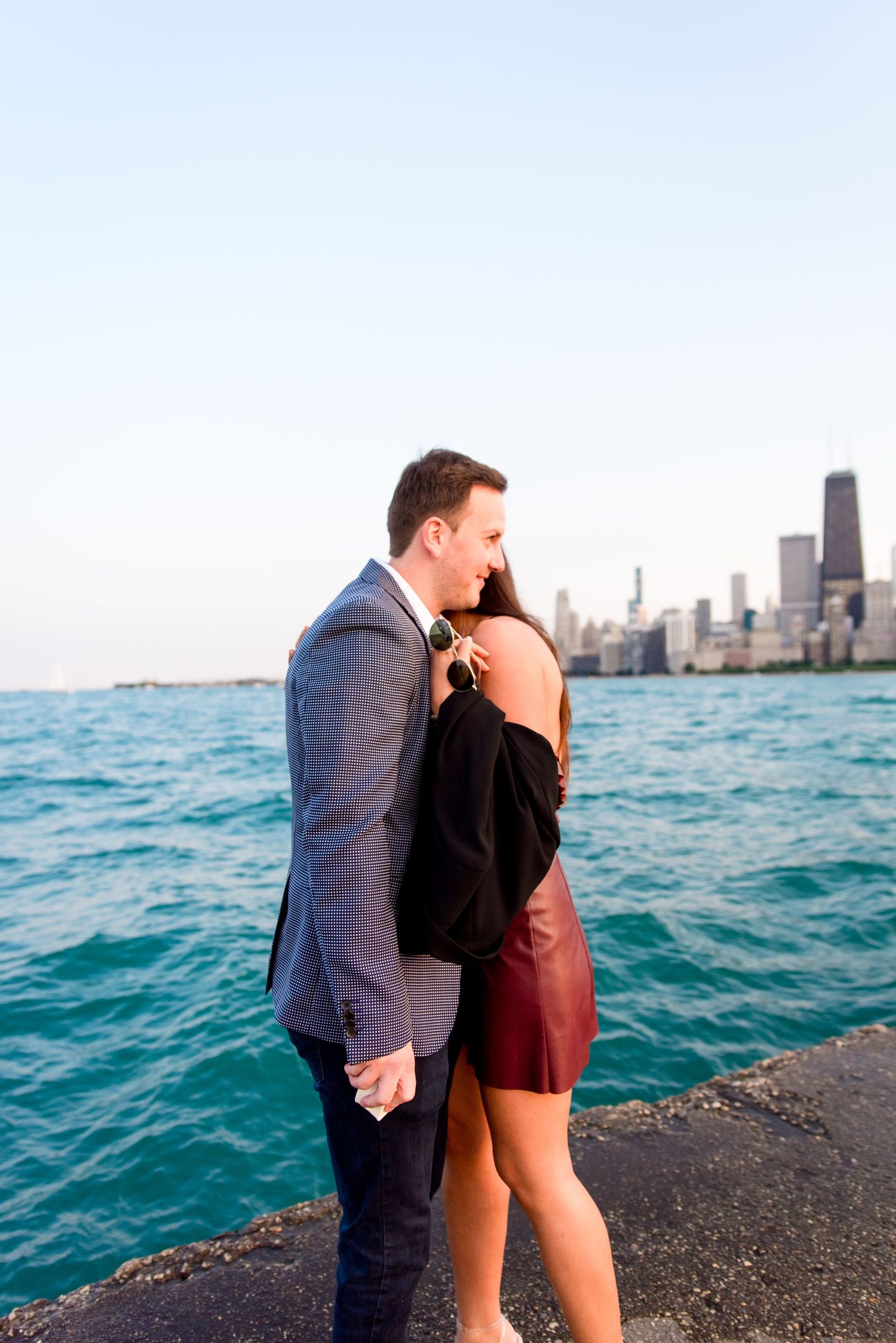 man and woman hugging after Chicago proposal at North Avenue Beach pier