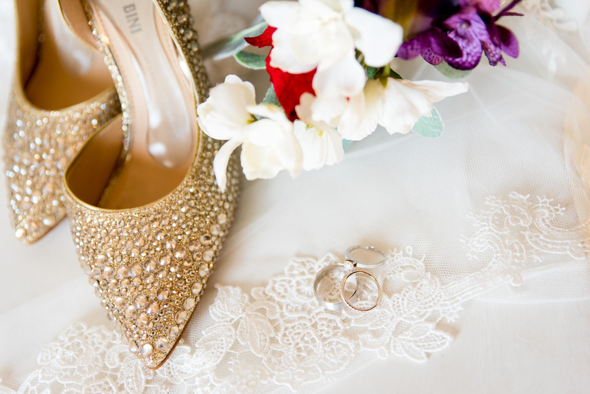 gold rhinestone wedding shoes with bouquet, veil, and wedding rings