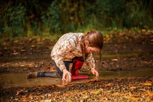 Girl playing in mud