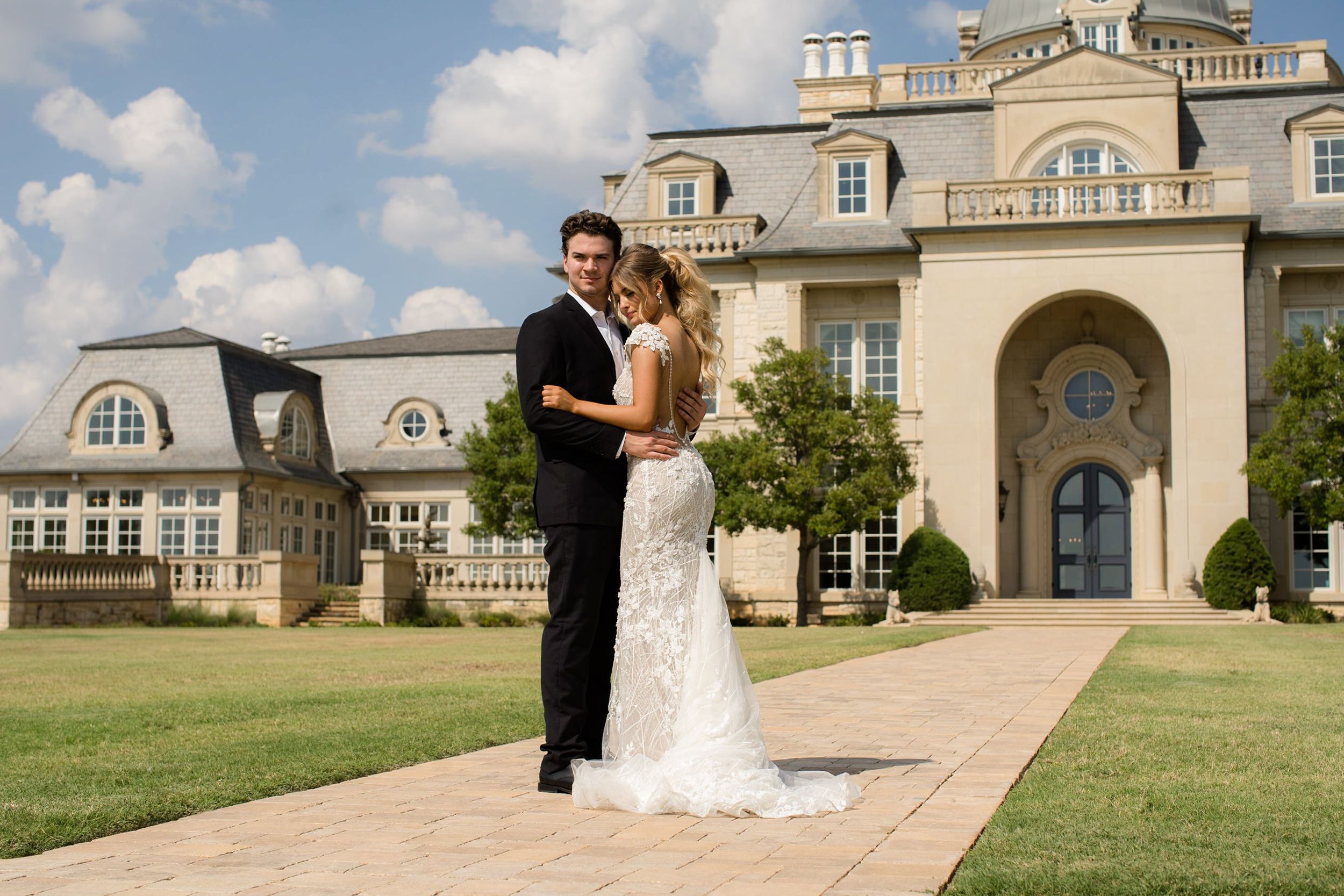 Bride and groom in front of The Olana wedding venue in Dallas, TX. Wedding photo by Dallas TX wedding photographers