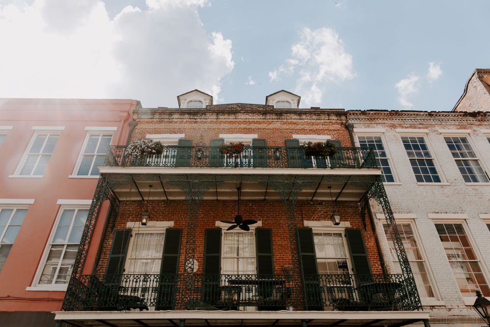 Looking up view of a building in the French Quarter with a double balcony, New Orleans Elopement Photographer