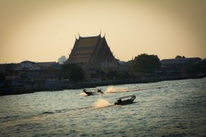 Long-tail boats crossing on the Chao Phraya river in Bangkok Thailand
