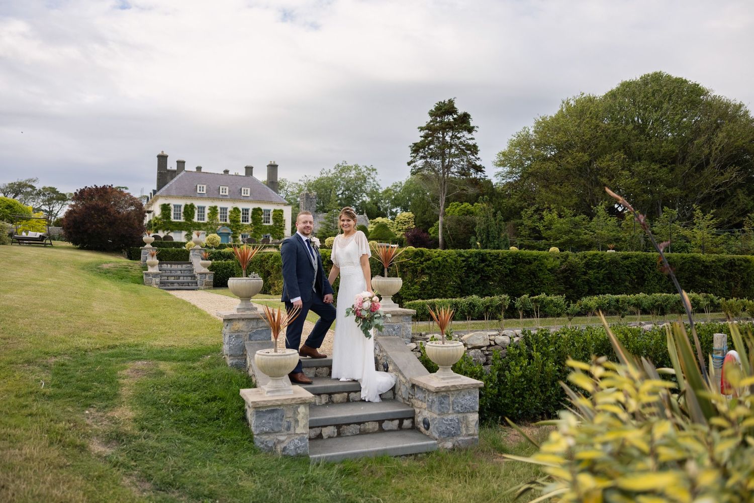 the grounds of gileston manor with bride and groom
