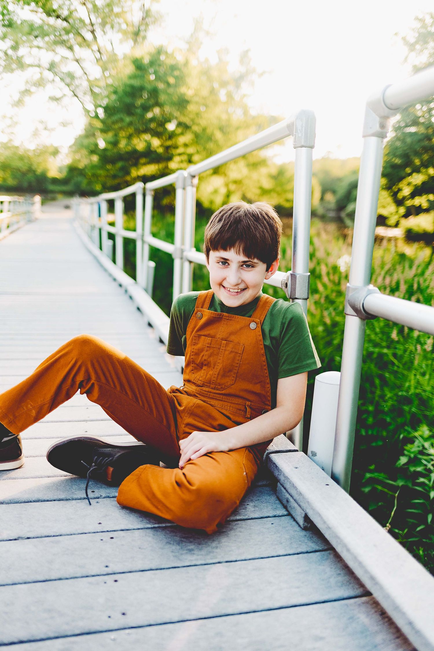 Styled photoshoot of little boy in cute trousers by delafield fish hatchery in downtown delafield wi