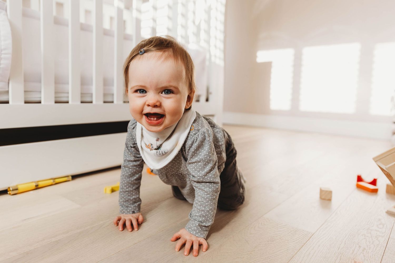one year old girl smiling to camera