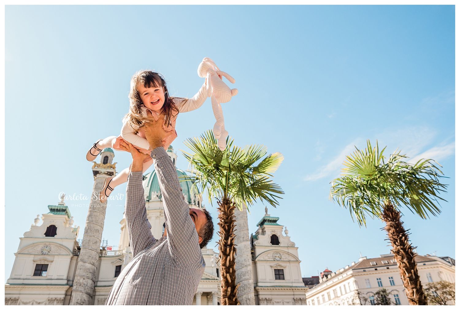 Father and daughter playing in Vienna City Centre for a family photoshoot