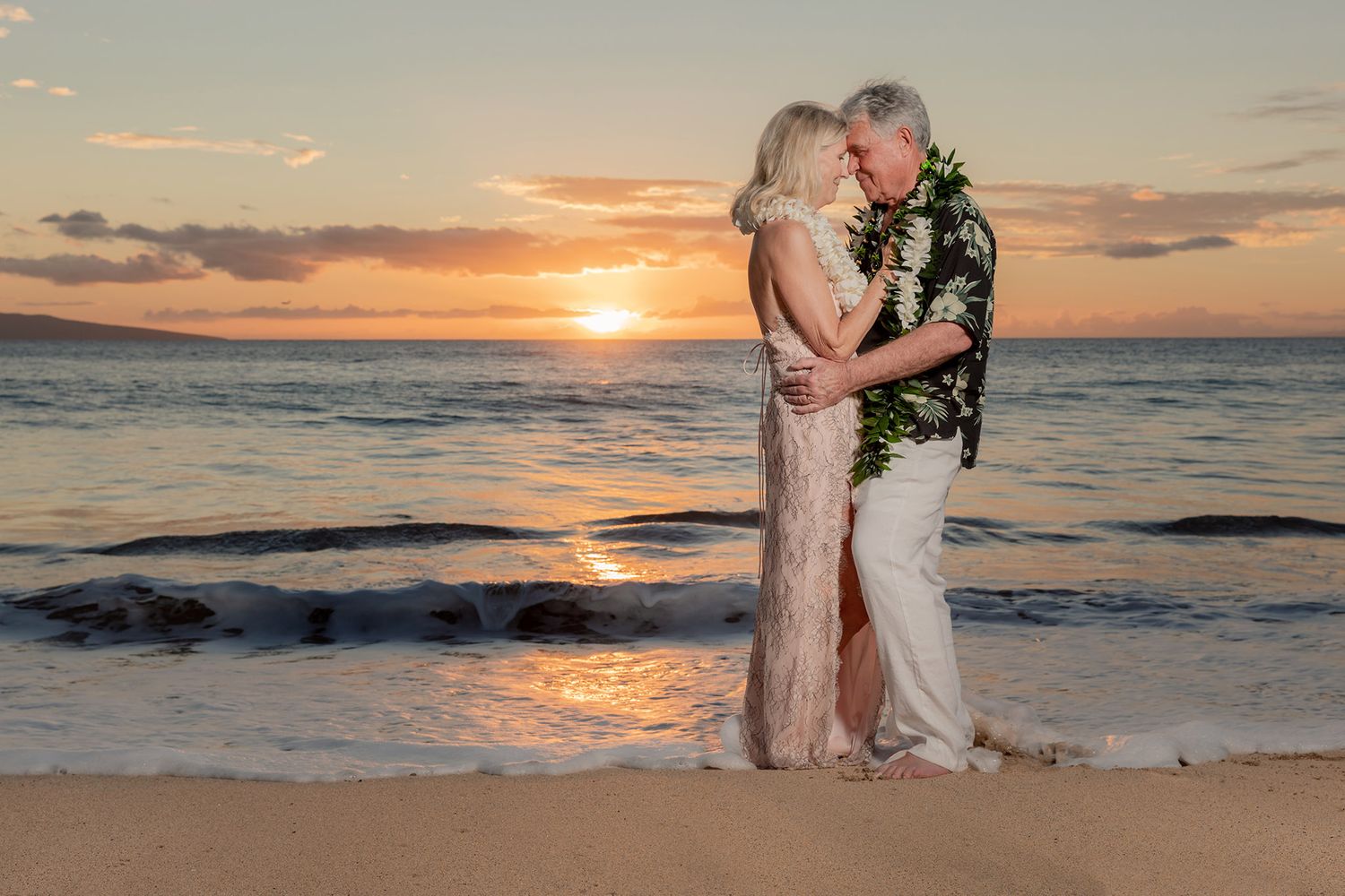 Couple at sunset after maui beach wedding
