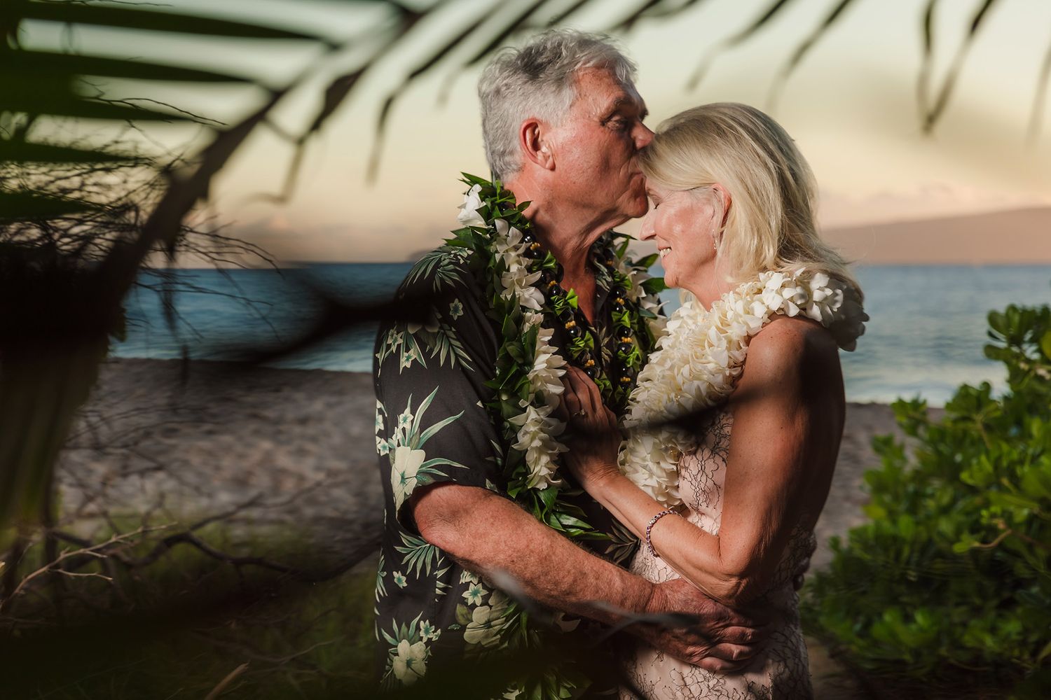 palm frond hides wedding kiss