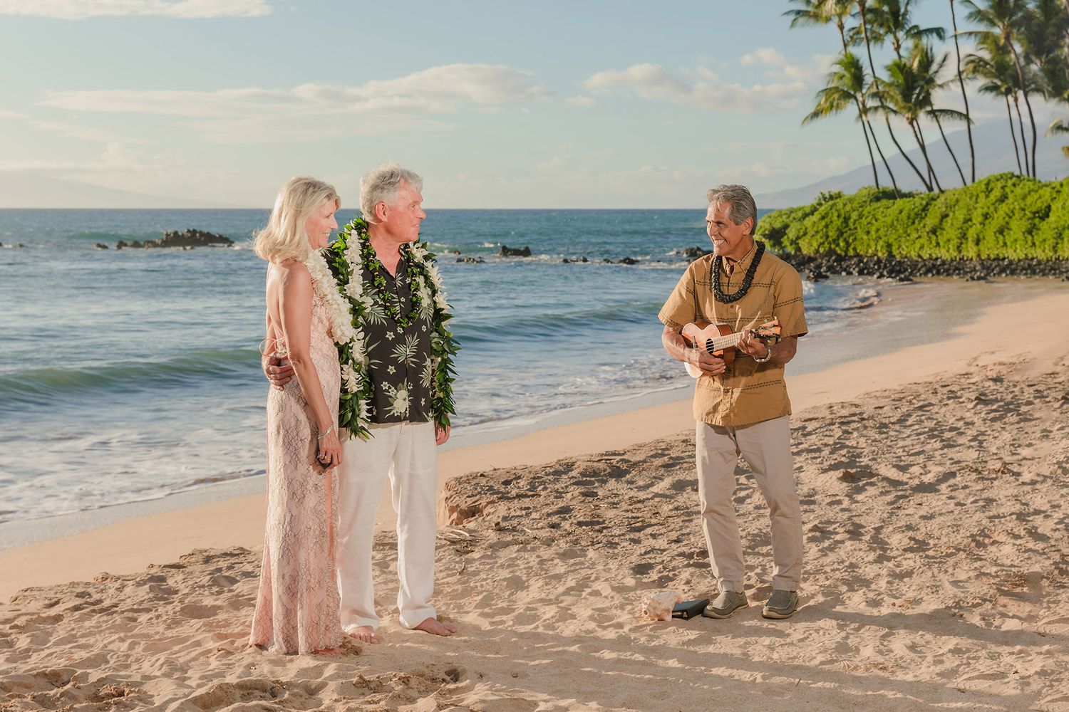 Officiant plays ukulele for beach wedding