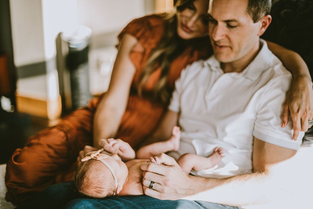 A family poses for a photo during their in-home lifestyle session by Natalie Dyer Photography in Fort Collins, Colorado.