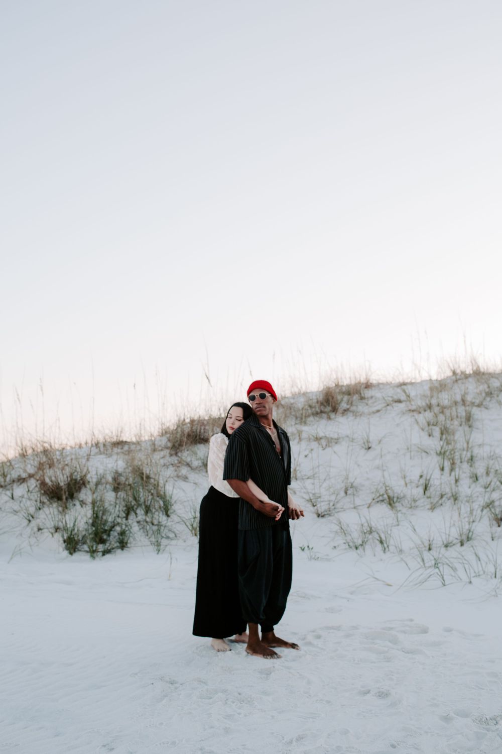 woman holding a man from behind during their Pensacola Beach photoshoot