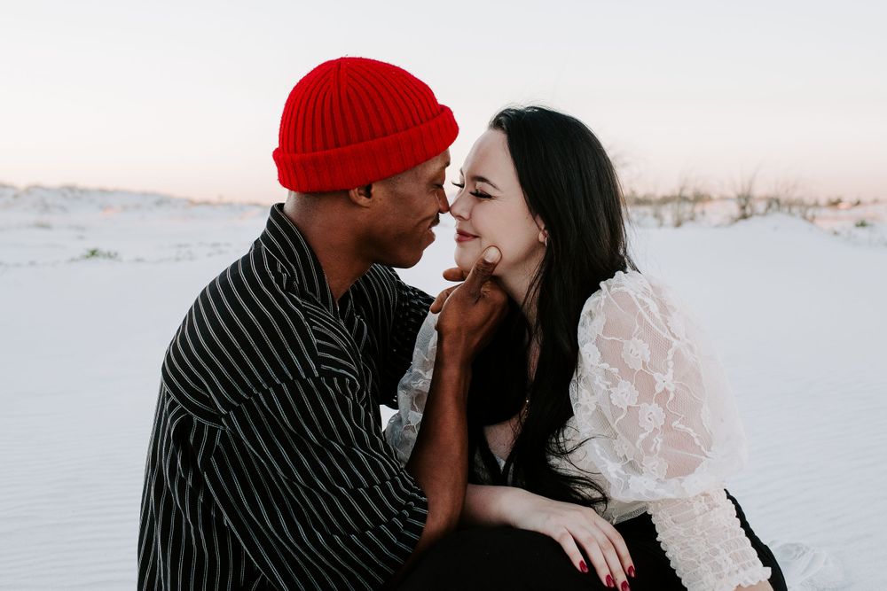 man and woman about to kiss on the beach during their Destin couple photoshoot