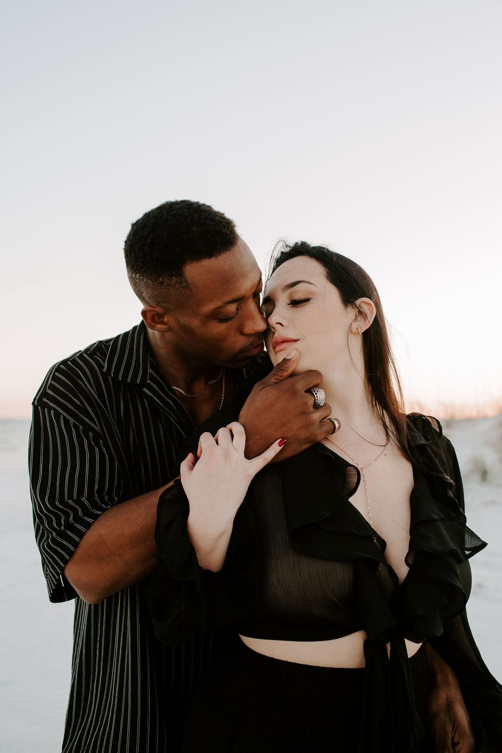 man and woman about to kiss during their beach photoshoot in Destin, Florida
