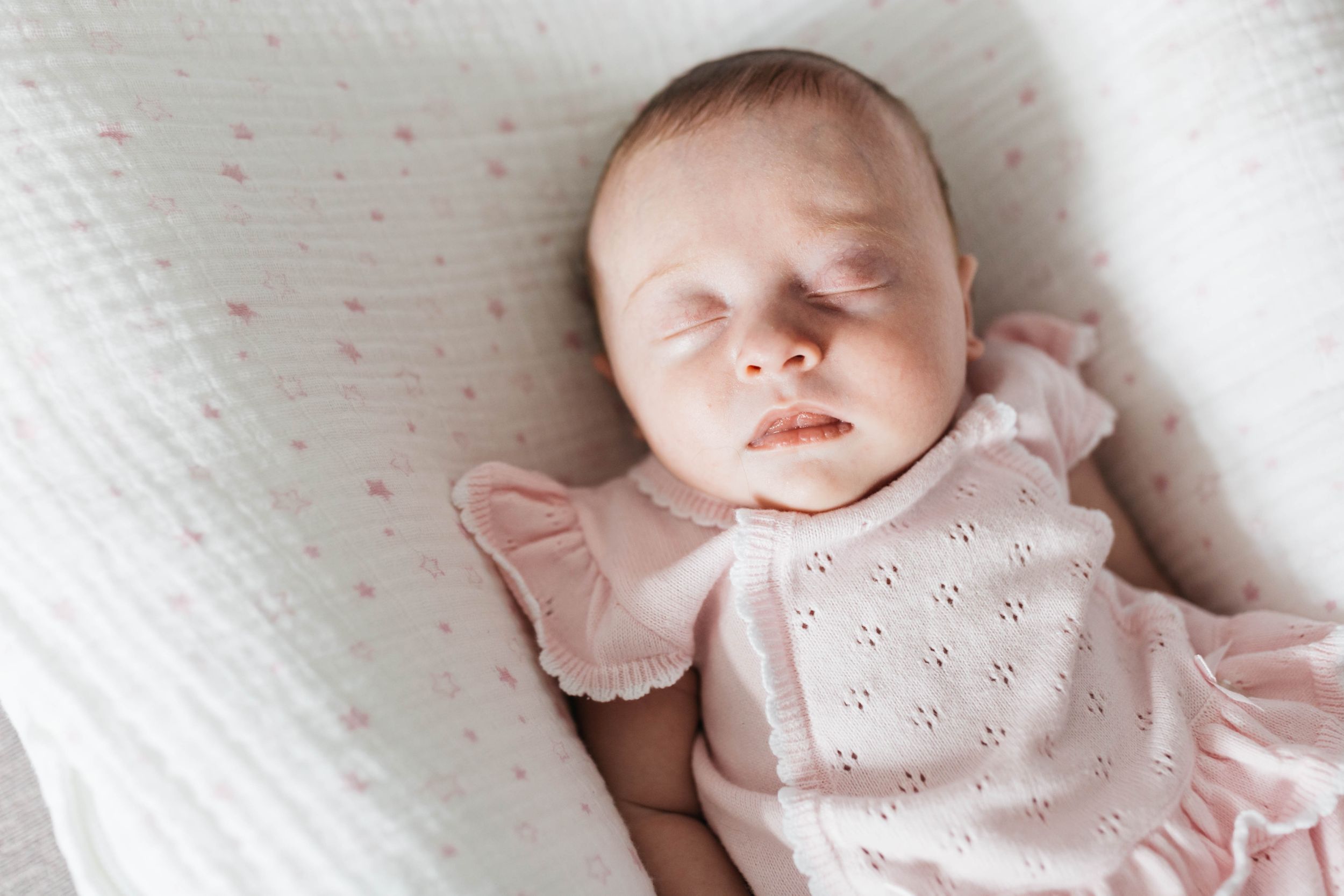 the number one reason to book in-home newborn photo session sleeping baby girl