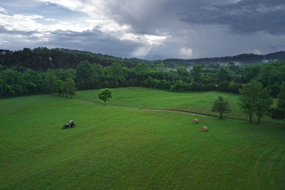 Sunbeams break through the clouds and light up the area around a Eureka Springs farm.