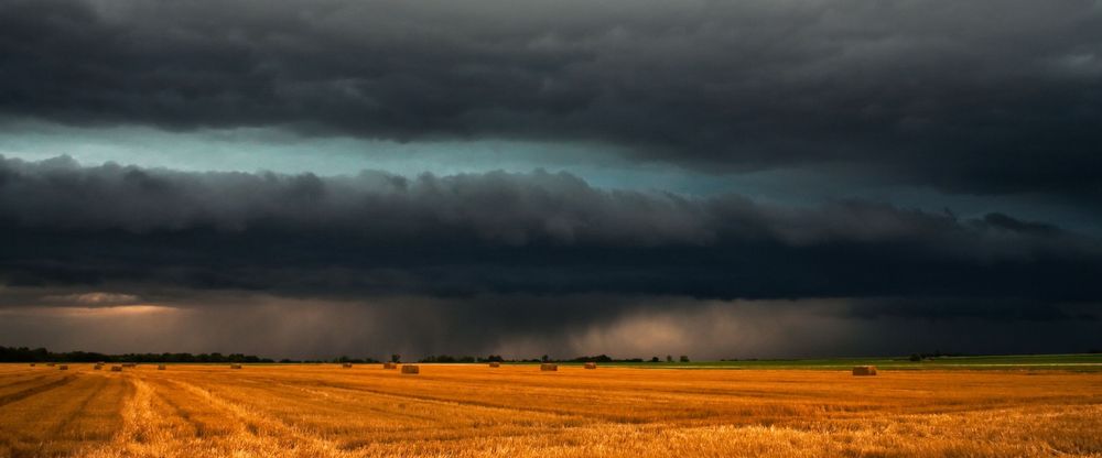 A shelf cloud filled with hail stones move over a hay field in Italy, Texas.