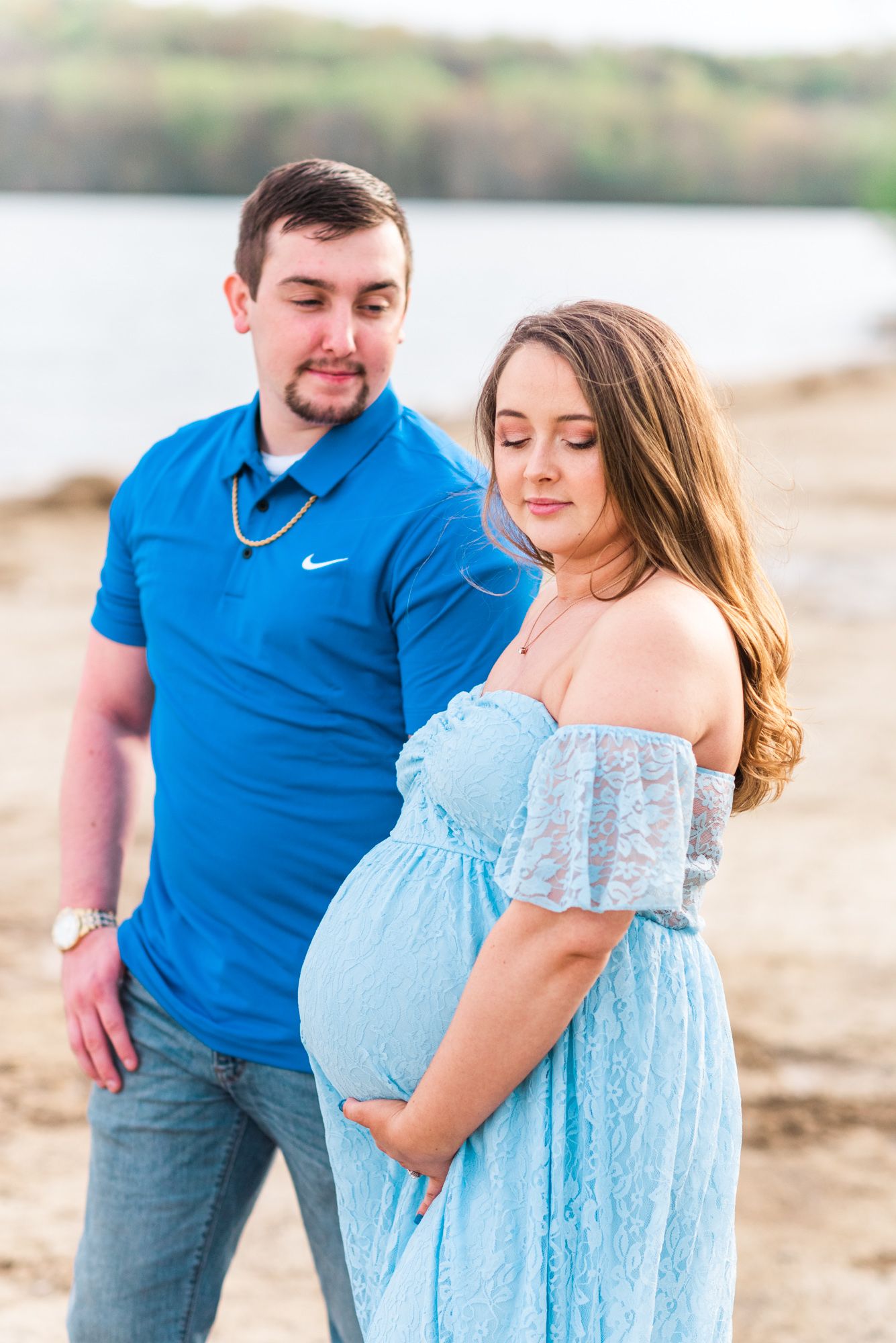 Maternity session with couple on beach in golden hour sunlight at Moraine State Park, Pennsylvania
