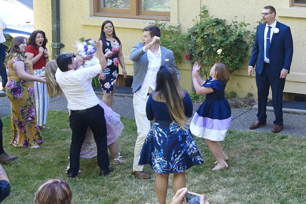 Groomsmen catches bouquet but runs into bridesmaid during bouquet toss at Lord Mansion, Olympia, WA