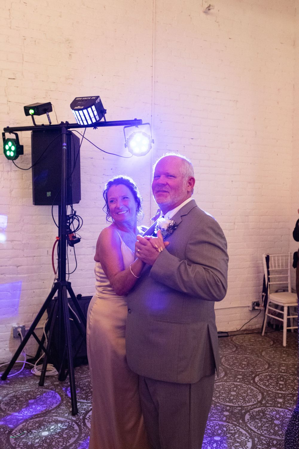 The mother of the bride and father of the bride dancing together at the wedding reception in Brainerd, MN