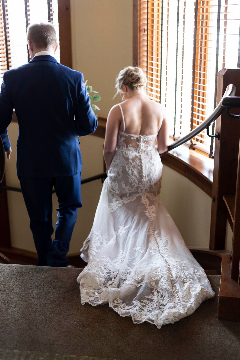 A bride and groom entering a spiral staircase at the Bunker Hill Golf Club in Coon Rapids, Minnesota