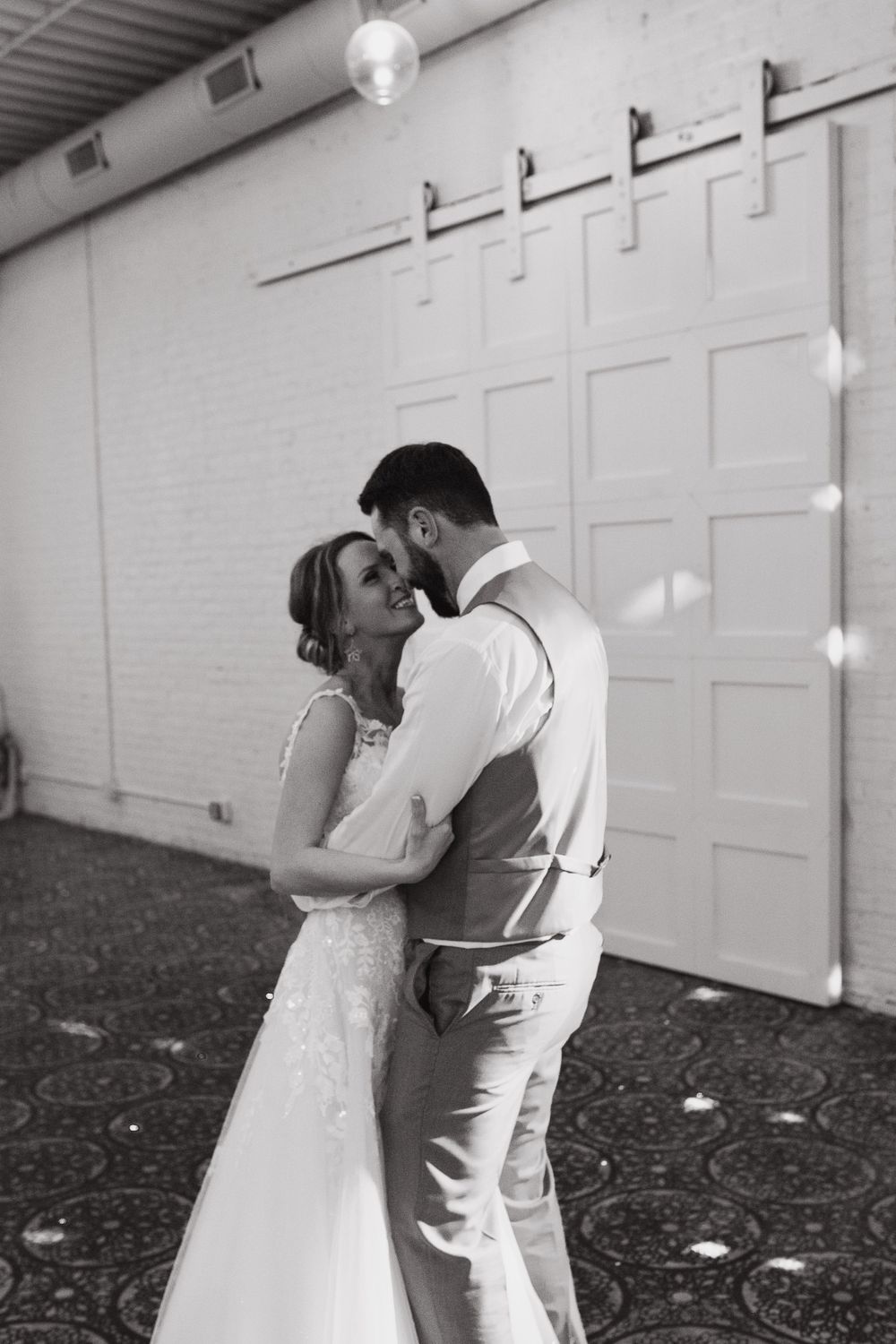 A groom and his bride dancing romantically with their faces touching at the Northern Pacific Center in Brainerd, MN