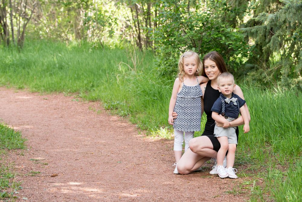 Mommy with her 2 kids on a trail in the spring at Rock Ledge Ranch
