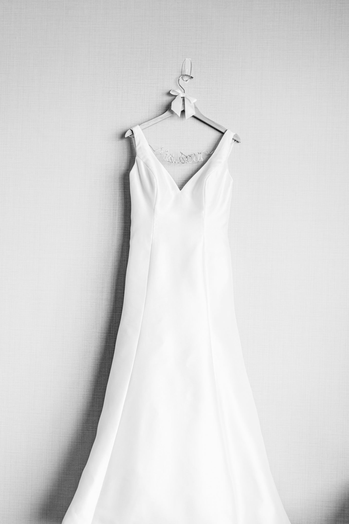 wired hanger with white bow displays formal chicago wedding dress