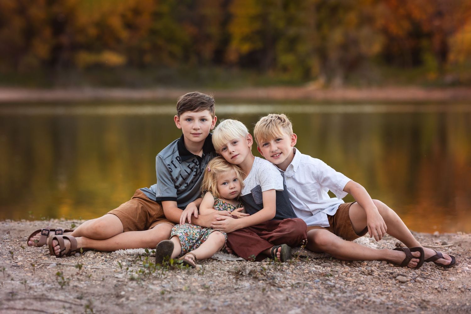 four kids on beach with water and fall colors